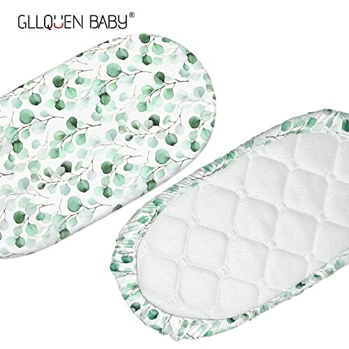 Two baby bassinet mattress pads with green leaf pattern and quilted design.