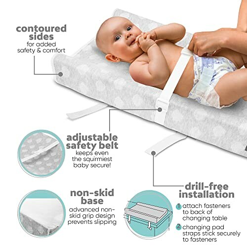 Baby on changing pad with contoured sides, safety belt, and non-skid base.