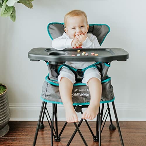 Baby sitting in a high chair eating snacks