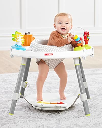 Baby in activity center with toys