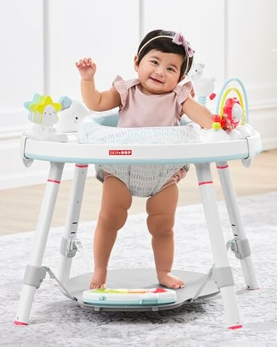 Baby smiling in an activity center with toys