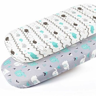 Two baby mattress sheets with elephant patterns, one white and one gray.