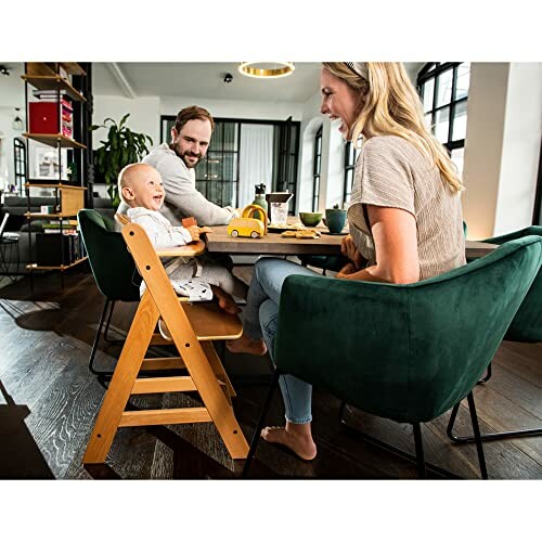 Family with a baby sitting at a dining table.