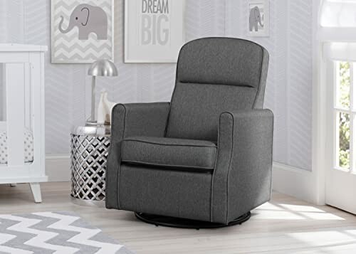 A woman sitting in a gray nursery glider chair reading a book in a cozy room.