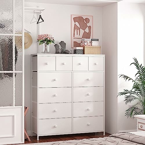 White storage cabinet with drawers in a bedroom.