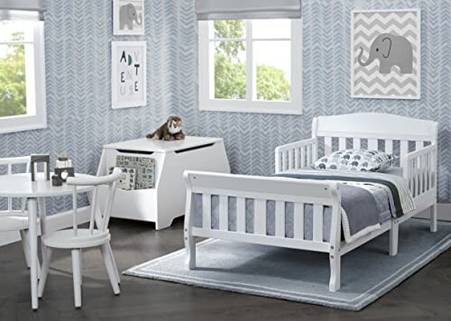 Toddler bedroom with white bed, table, and elephant decor.