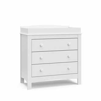 White baby changing table with three drawers.