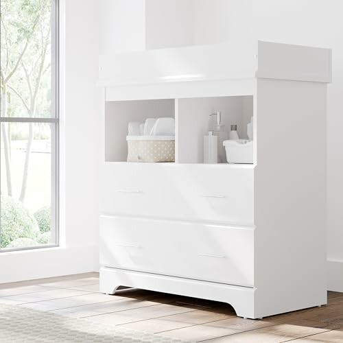 White nursery changing table with shelves and drawers